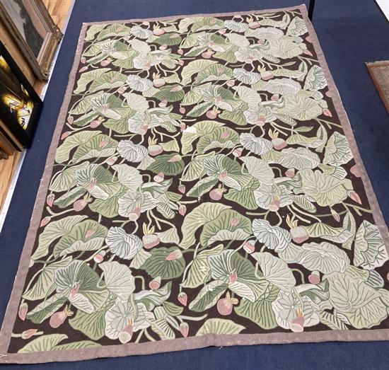 A needlework rug, worked with a water lily design, 264 x 180cm